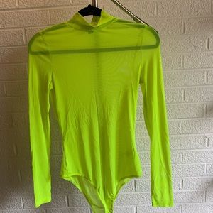 Neon green sheer body suit with long sleeves.